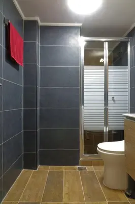 a bathroom with a glass shower and a toilet at You & Me Cozy Apartments BY ZAIN in Athens