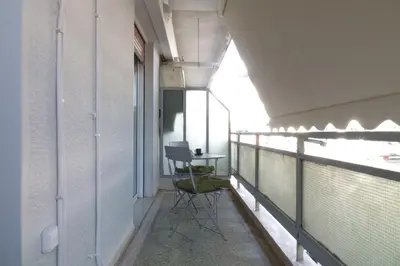 a balcony with a table and chairs on it at You & Me Cozy Apartments BY ZAIN in Athens