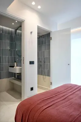 a bedroom with a shower and a sink and a bed at Twinn Downtown Piraeus, Santikos Collection in Piraeus