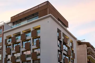 a building with balconies on the side of it at Twinn Downtown Piraeus, Santikos Collection in Piraeus
