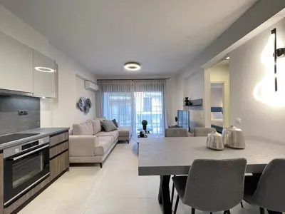 a kitchen and living room with a table and chairs at Athenean Gem near Athens Metro Mall in Athens