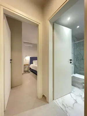 a bathroom with a door leading to a bedroom at Athenean Gem near Athens Metro Mall in Athens