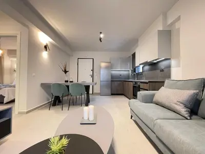 a living room with a couch and a table at Athenean Gem near Athens Metro Mall in Athens