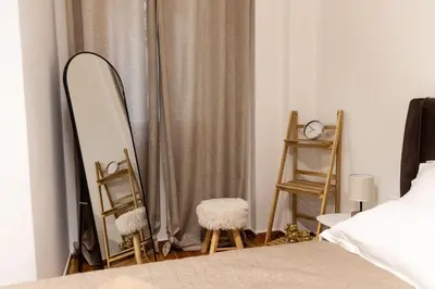 a bedroom with a mirror and two chairs and a bed at Sympatico Central Apartment in Athens in Athens