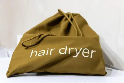 a green bag with the words hair dyeer written on it at Sympatico Central Apartment in Athens in Athens