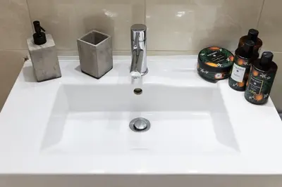a white sink with two bottles on top of it at Sympatico Central Apartment in Athens in Athens