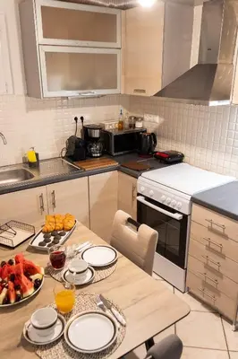 a kitchen with a table with plates and fruit on it at Sympatico Central Apartment in Athens in Athens