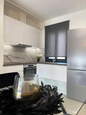 a kitchen with a table with a candle on it at Athenean Modern Escape near Marina Flisvos in Athens