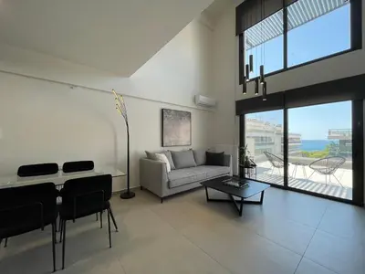 a living room with a couch and a table at Athenean Modern Escape near Marina Flisvos in Athens