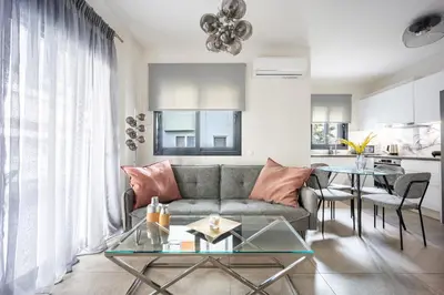 a living room with a couch and a table at Athenean Modern Escape near Marina Flisvos in Athens