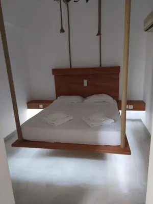 a bed with two white towels on it in a room at Golden Star Praxitelous in Agia Marina Aegina