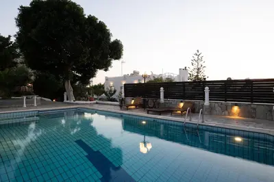 a large blue swimming pool with lights on it at Villa Mare Nostrum Sounio in Sounio