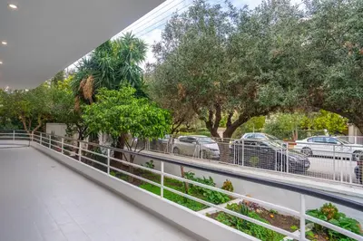 a balcony of a building with trees and cars at Glyfada Diamond Residence - 3 Master Bedrooms in Athens