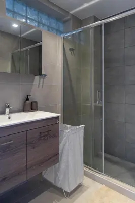 a bathroom with a glass shower and a sink at Glyfada Diamond Residence - 3 Master Bedrooms in Athens