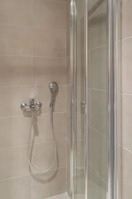 a shower with a glass door with a shower head at Glyfada Diamond Residence - 3 Master Bedrooms in Athens