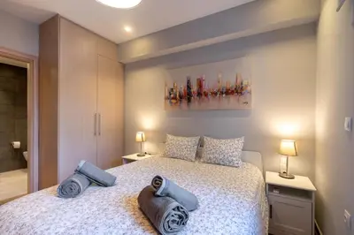a bedroom with a bed with towels on it at Glyfada Diamond Residence - 3 Master Bedrooms in Athens