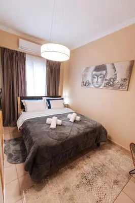 a bedroom with a bed with two stuffed animals on it at Peaceful moments in Athens