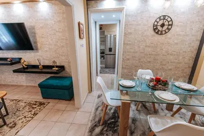 a dining room with a glass table and white chairs at Peaceful moments in Athens