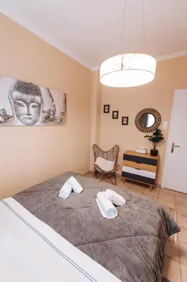 a bedroom with a large bed with two towels on it at Peaceful moments in Athens