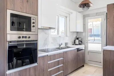 a kitchen with a sink and a microwave at Charming 2 Bdrm Glyfada Getaway in Athens