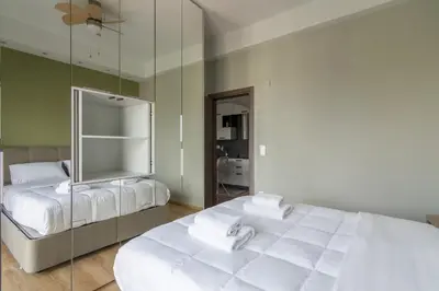 a bedroom with two beds and a large mirror at Stratum Apartment by LobbySquare in Athens