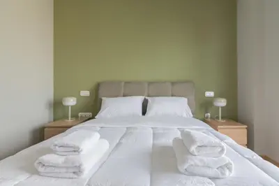 a bedroom with a bed with white towels on it at Stratum Apartment by LobbySquare in Athens