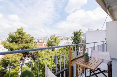 a balcony with a table and chairs and a view at Stratum Apartment by LobbySquare in Athens