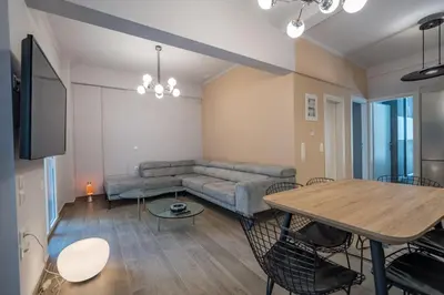 a living room with a couch and a table at Luxury Serenity in Piraeus