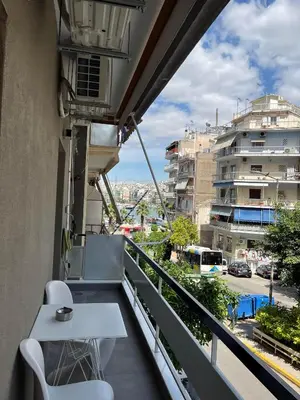 a balcony with a table and a view of a city at Luxury Serenity in Piraeus