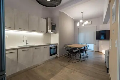 a kitchen and dining room with a table and chairs at Luxury Serenity in Piraeus