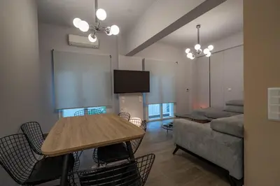 a living room with a table and a couch at Luxury Serenity in Piraeus