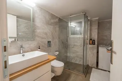 a bathroom with a shower and a sink and a toilet at Luxury Serenity in Piraeus