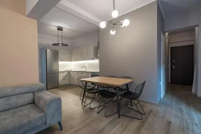 a living room with a table and chairs and a couch at Luxury Serenity in Piraeus