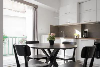 a kitchen with a table and chairs in a kitchen at Acropolis Urban Life in Athens