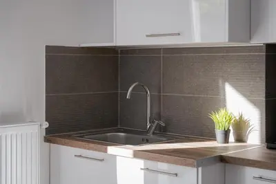 a kitchen with a sink and a tile wall at Acropolis Urban Life in Athens
