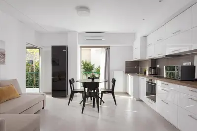 a kitchen and living room with a table and chairs at Acropolis Urban Life in Athens