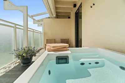 a bath tub in a room with a balcony at ACRON 12 penthouse Acropolis suites in Athens