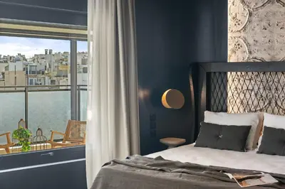 a bedroom with a bed and a large window at ACRON 12 penthouse Acropolis suites in Athens