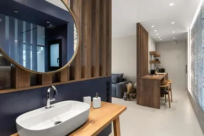 a bathroom with a sink and a mirror at ACRON 12 penthouse Acropolis suites in Athens