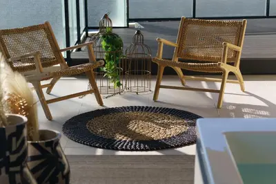 a group of chairs and a vase on a porch at ACRON 12 penthouse Acropolis suites in Athens