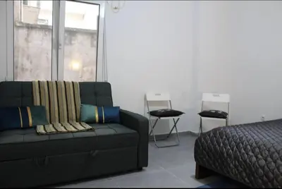 a living room with a couch and a bed at Cozy apartment in Athens center in Athens