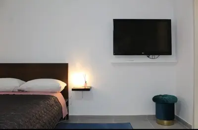 a bedroom with a bed and a flat screen tv at Cozy apartment in Athens center in Athens