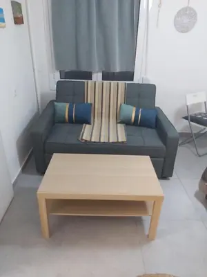 a couch and a coffee table in a living room at Cozy apartment in Athens center in Athens