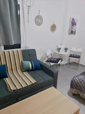 a living room with a couch and a table at Cozy apartment in Athens center in Athens