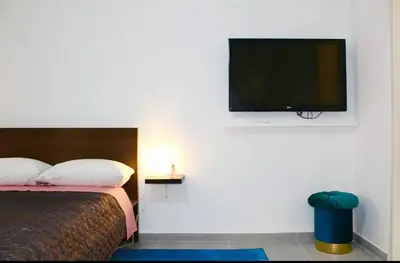 a bedroom with a bed and a flat screen tv at Cozy apartment in Athens center in Athens