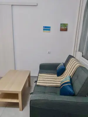 a living room with a couch and a table at Cozy apartment in Athens center in Athens