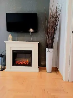 a living room with a fireplace with a flat screen tv at Stylish Central Cozy one BEDROOM Apartment in Athens