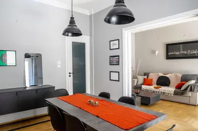 a living room with a table and a couch at Stylish Central Cozy one BEDROOM Apartment in Athens