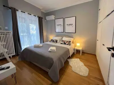 a bedroom with a bed with two towels on it at Stylish Central Cozy one BEDROOM Apartment in Athens