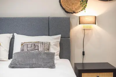 a bedroom with a bed with a pillow and a lamp at Exclusive Mavili Suite by CloudKeys in Athens